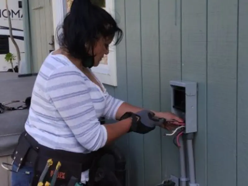 Licensed electrician wiring an exterior subpanel in Emerald Isle