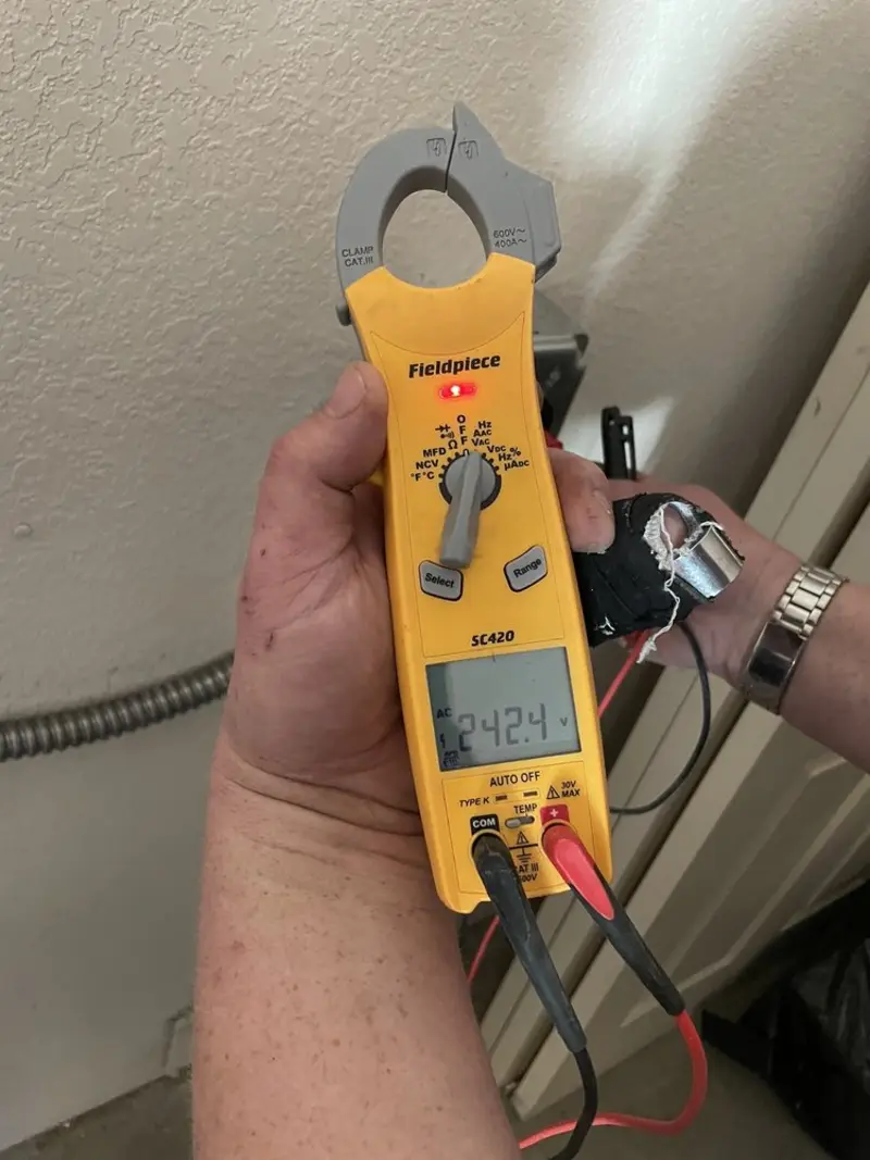 Voltage testing with clamp meter during Ceiling Fan Installation in Emerald Isle